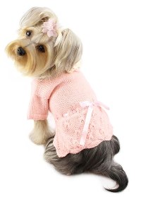 Klippo - Adorable pink hand-knitted sweater with adjustable ribbon intertwined around the waist.  Accented with a crocheted flower at the neckline.  A small D-Ring near the neckline for a "Klippo" charm or ID tag.