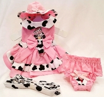 Platinum Puppy Couture - Cupcake Cowgirl Embroidered 4pc Harness Dress Set - Made with a bubble gum pink fabric, this harness dress set is too adorable!. The contrasting fabric used is a white and black cow print. The top portion of the dress has an adorable embroidered design of a cow eating a sweet cupcake. The dress has a triple ruffle design with a full bow in the center. This dress has an added D-ring for easy leash access. This set comes with harness dress; matching sun hat, panty and leash. The darling matching panty is great to use if your pet is in season or just as part of the outfit. It also looks darling on those dogs with a slightly longer body (if dresses are usually too short).  Your little girl is sure to be the center of attention in this little outfit!!!